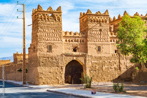 View of traditional riad kasbah building with beautiful Arabic architecture in Agdz town, Morocco, North Africa photo