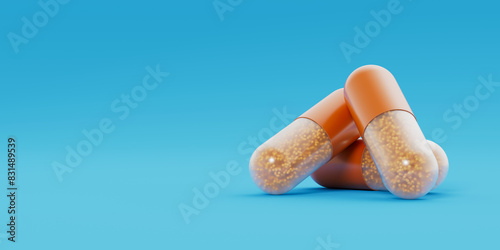 Quadro su tela Three orange transparent capsules, pills with orange granules inside lay on blue background