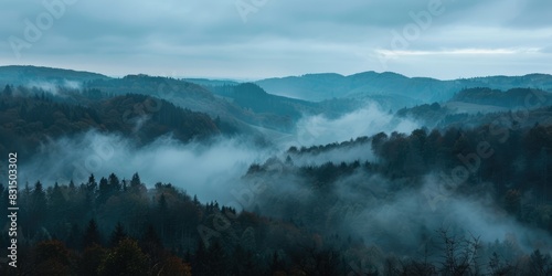 landscape view over foggy forest with hills