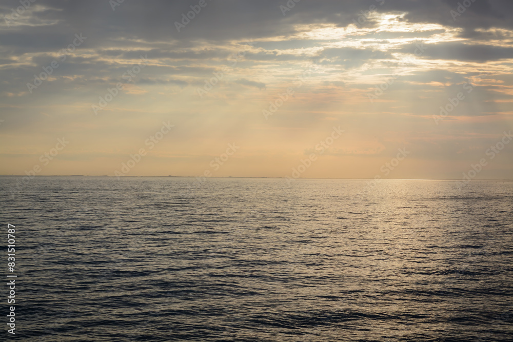 View of the seascape in the evening with sunset lighting in cloudy weather View of the seascape in the evening with sunset lighting in cloudy weather