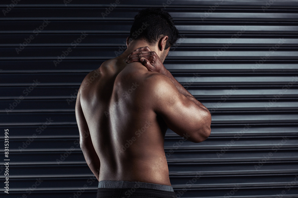 Neck pain, athlete and man with injury and body ache in fitness training, exercise or workout. Dark background, sore muscles or sports person with bruised spine in accident, gym studio or emergency