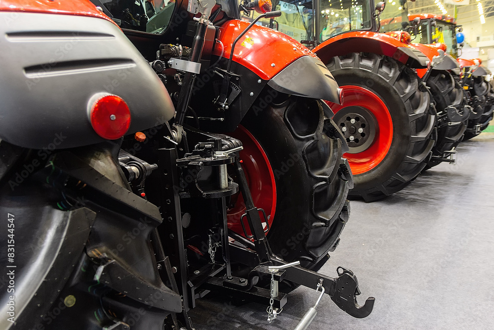 New agricultural tractors are sold for work in the field. Mechanical engineering, industry New agricultural tractors are sold for work in the field. Mechanical engineering, industry
