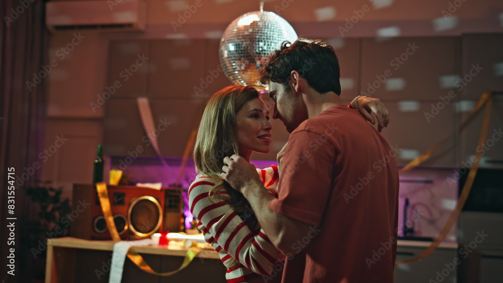 Dancing couple expressing tenderness under disco ball after night party close up Dancing couple expressing tenderness under disco ball after night party close up
