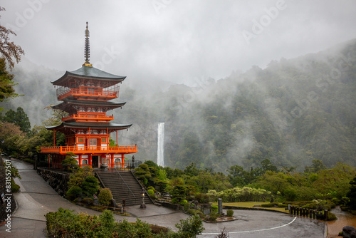 Seiganto-ji Temple Pagoda with Nachi Falls behind on Kumano Kodo hiking trail, April, Japan