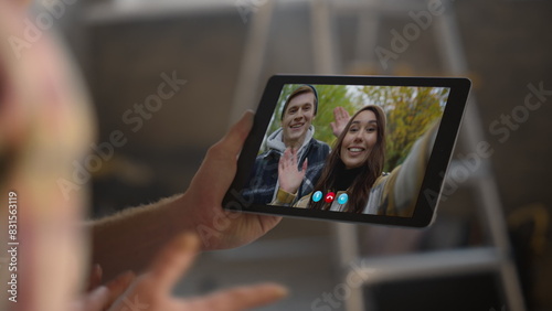 Smiling couple waving web call closeup. Unknown man talking tablet conference