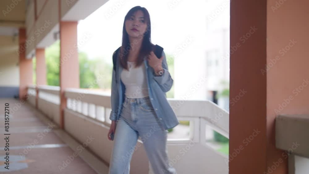A woman in a blue jacket and jeans is walking down a set of stairs. Concept of casualness and ease, as the woman is dressed comfortably and he is in a relaxed state. The stairs themselves are a simple A woman in a blue jacket and jeans is walking down a set of stairs. Concept of casualness and ease, as the woman is dressed comfortably and he is in a relaxed state. The stairs themselves are a simple