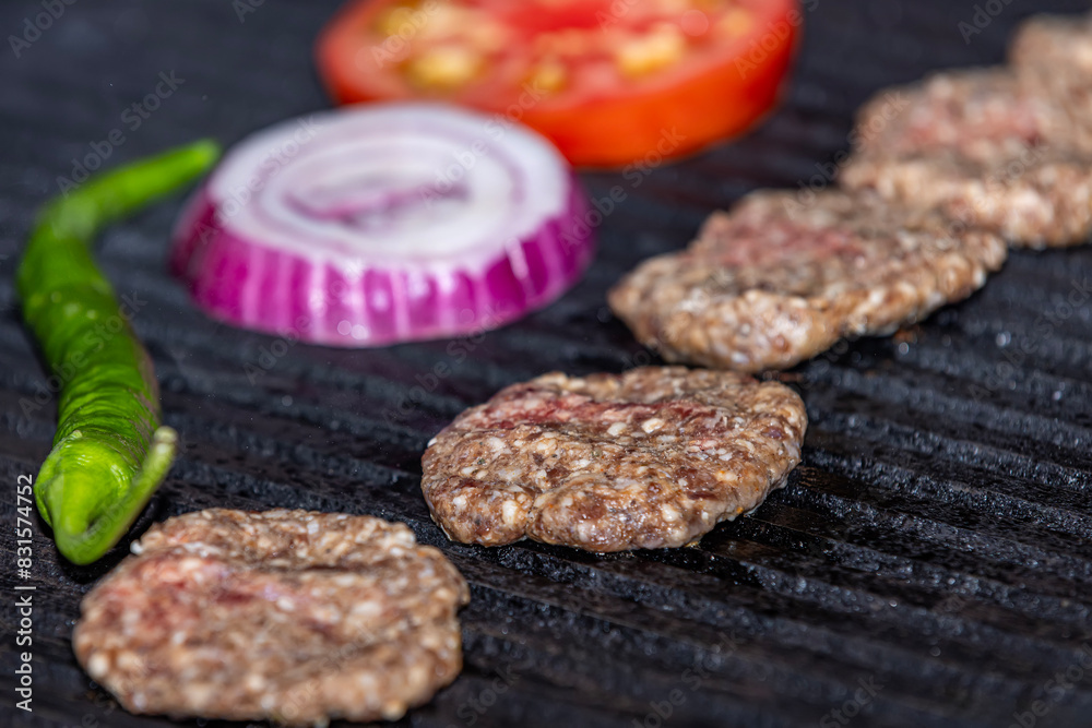 Chef is cooking meatballs on the grill. Cut the meatballs into pieces ready to grill. The chef is turning the meatballs. Chef is cooking meatballs on the grill. Cut the meatballs into pieces ready to grill. The chef is turning the meatballs.