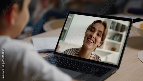 Kid chatting teacher online at home closeup. Distance education communication