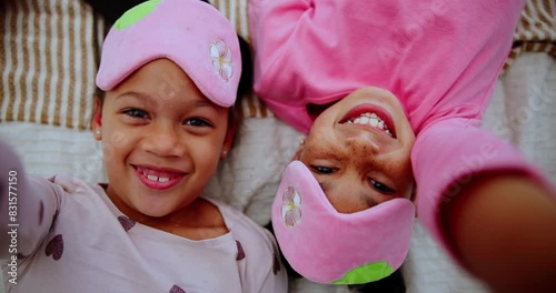 Sisters, bed and selfie with laughing or smile in pyjamas with sleepover for child development in house. Memories, cheerful and siblings for happiness on weekend with love for family with funny.