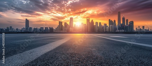 Panoramic view of empty road side with city skyline. Sunset scene.