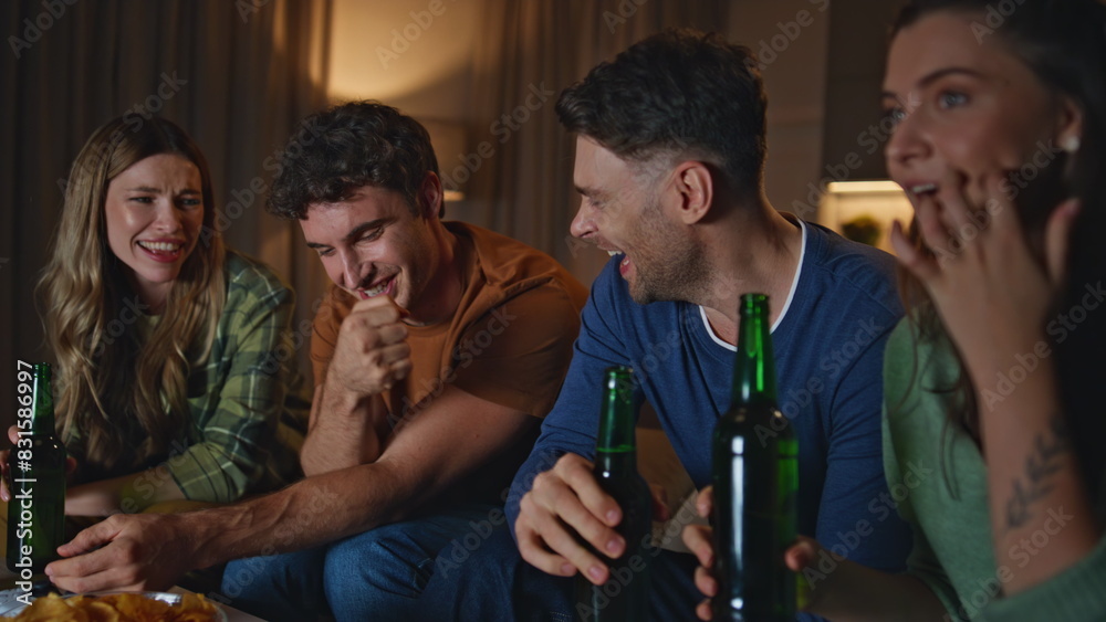 Fototapeta premium Smiling group people joking together at home gathering late evening close up.