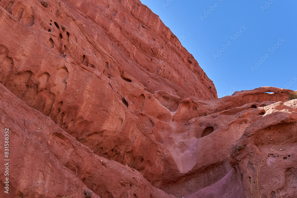 Red rocky mountain with blue sky on background in Uquia, Quebrada de las señoritas, Argentina Red rocky mountain with blue sky on background in Uquia, Quebrada de las señoritas, Argentina