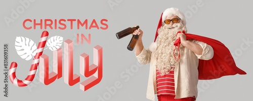 Banner with Santa Claus and text CHRISTMAS IN JULY on light background photo