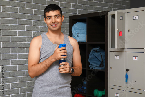 Sporty young man with water...