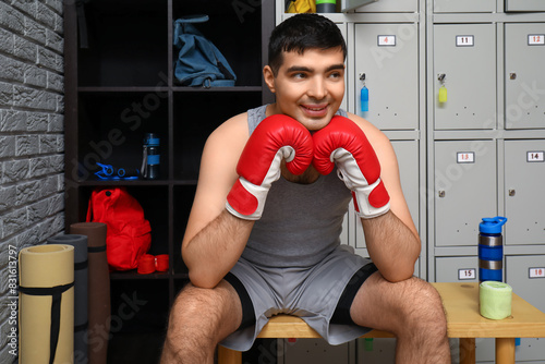 Sporty young man with boxin...