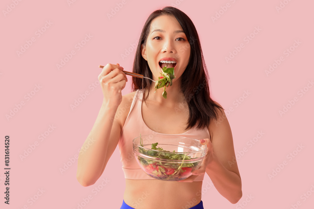 Beautiful young Asian woman with bowl of fresh vegetable salad on pink background. Weight loss concept Beautiful young Asian woman with bowl of fresh vegetable salad on pink background. Weight loss concept