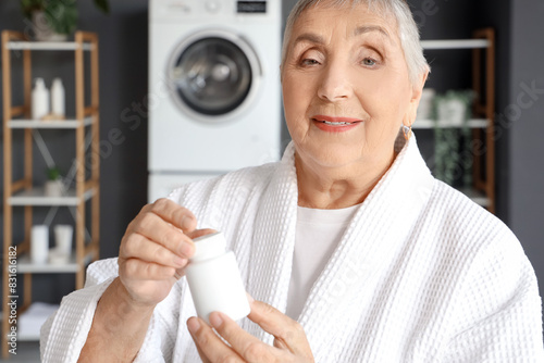 Senior woman with pill bott...