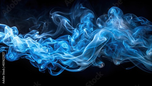 Abstract blue smoke swirling on a black background photo