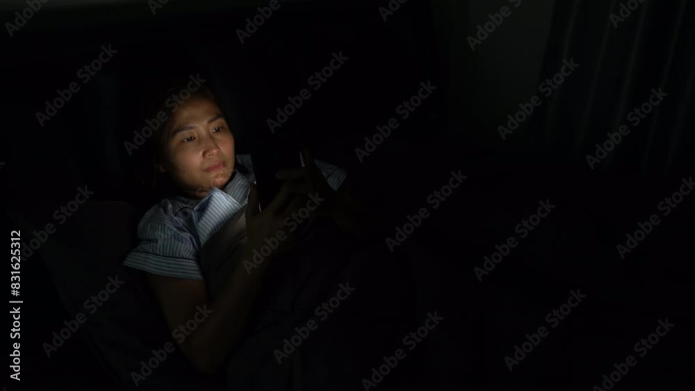 Asian woman play smartphone on the bed at night time,addict social media,Problem about eye Asian woman play smartphone on the bed at night time,addict social media,Problem about eye
