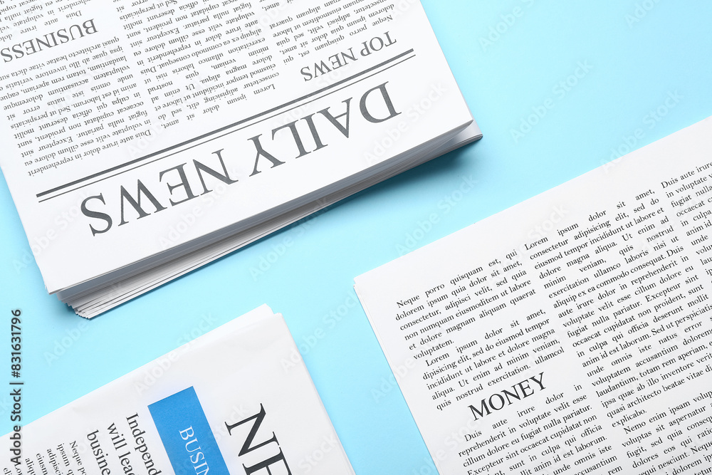 Obraz premium Different newspapers on blue background