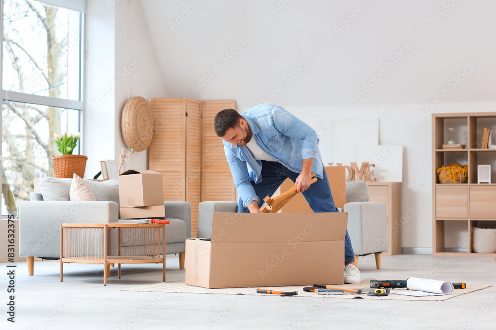Young man assembling furniture at home Young man assembling furniture at home