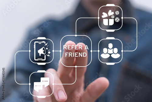 Obraz na płótnie Man using virtual screen presses text: REFER A FRIEND. Referral marketing or affiliate marketing concept. Invite friends to refer a friend loyalty program to win online reward. Refer and earn. w salonie