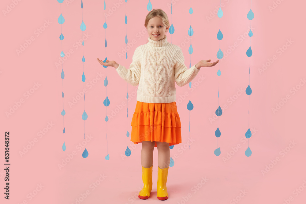 Adorable girl in rubber boots with paper raindrops on pink background Adorable girl in rubber boots with paper raindrops on pink background