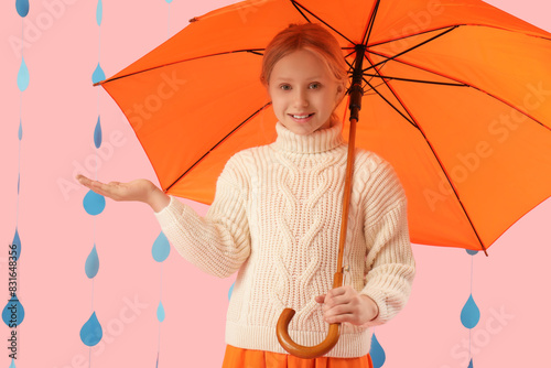 Adorable girl with umbrella...