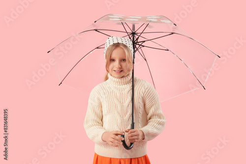 Adorable girl with umbrella...