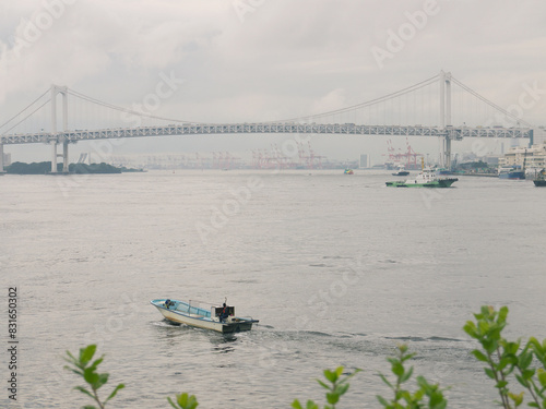 Rainbow Bridge and Tokyo bay view with fishing boat in harbour