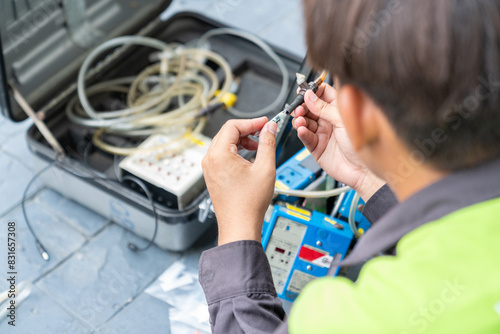 Technician ware sampling tube air quality in reel of machine pump.