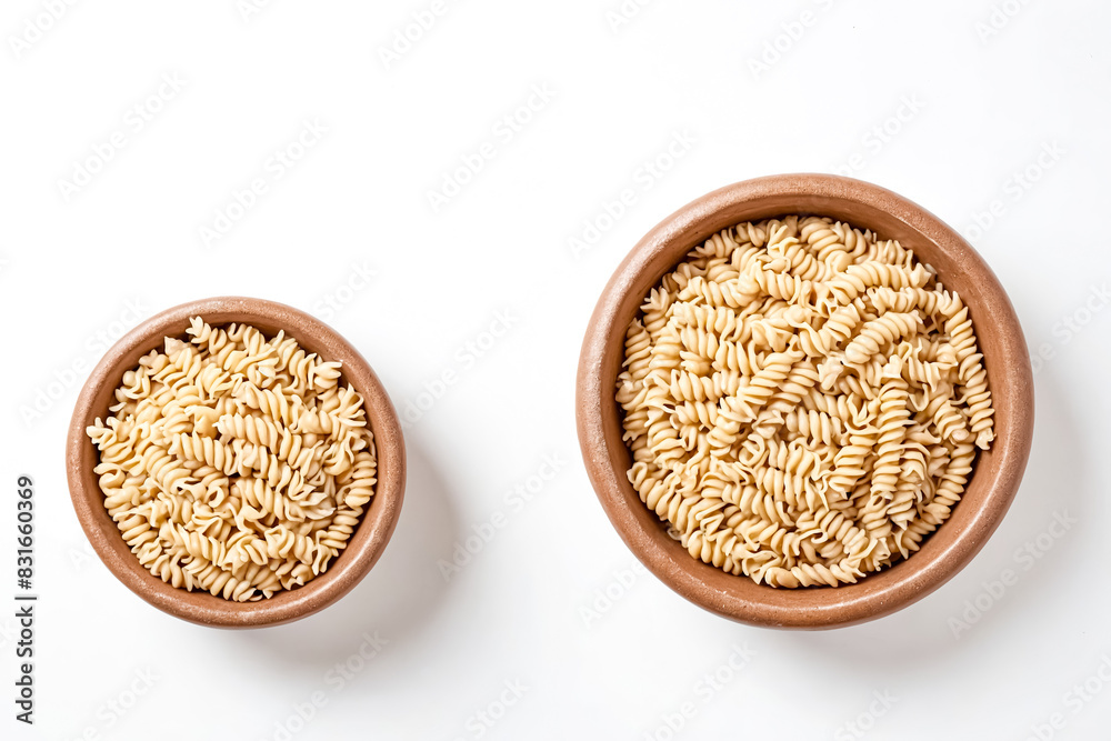 Uncooked Rotini Pasta in Clay Bowls on White Background Uncooked Rotini Pasta in Clay Bowls on White Background