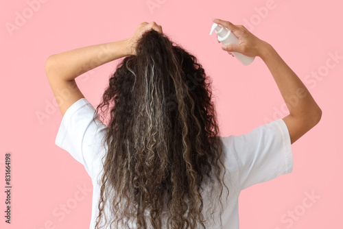 Vászonkép Beautiful young African-American woman with healthy curly hair and cosmetic prod