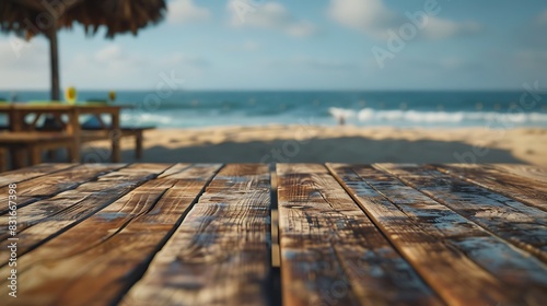 A tabletop view of a wooden surface with the distant sight of beach cafes blending into the coastal landscape.