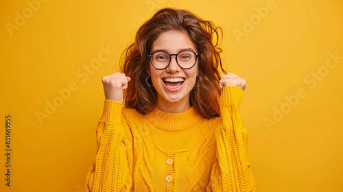 happy woman expresive glasses orange shirt orange background  photo
