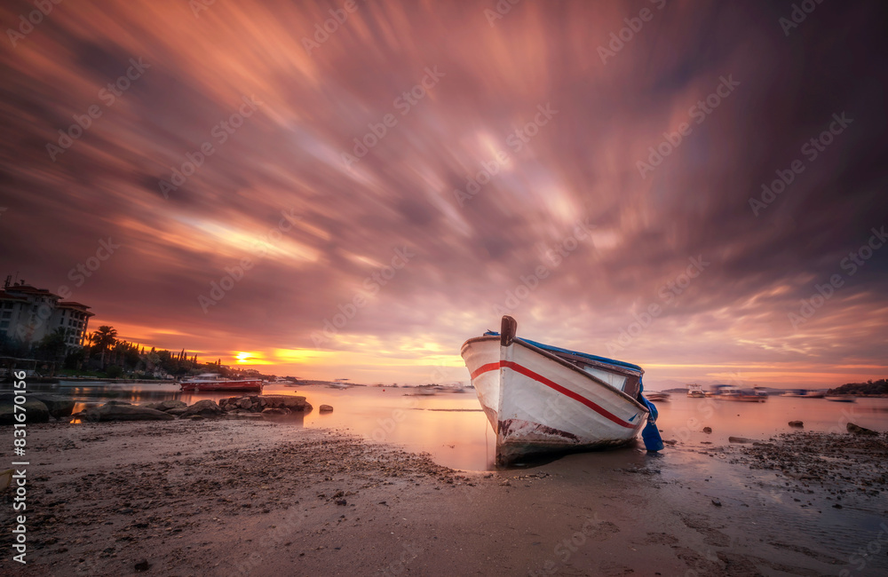 boats waiting in the reflective water clouds in the sky sunset colors boats waiting in the reflective water clouds in the sky sunset colors
