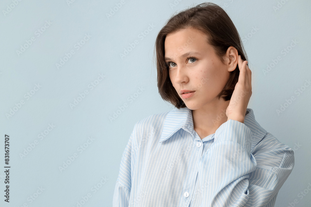 Beautiful young woman with acne problem on blue background Beautiful young woman with acne problem on blue background