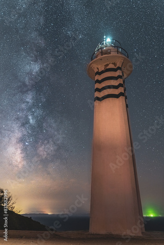 Karaburun Sarpincik lighthouse at night with stars and milky way photo