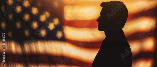 Silhouette of a man standing in front of an American flag. photo