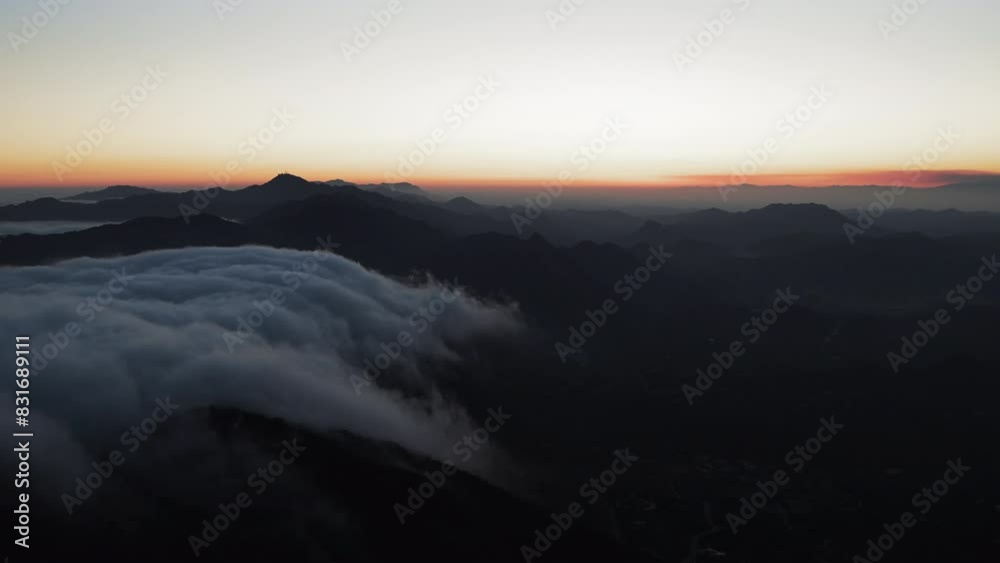 Aerial Panning Scenic Shot Of Dark Mountain Range In Clouds During Tranquil Sunset - Calico Bluff, Alaska Aerial Panning Scenic Shot Of Dark Mountain Range In Clouds During Tranquil Sunset - Calico Bluff, Alaska