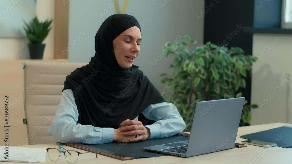 Muslim islamic woman in hijab female employer businesswoman Arabian business lady professional consultant lawyer girl talk video call online conference with laptop consult discuss documents in office Muslim islamic woman in hijab female employer businesswoman Arabian business lady professional consultant lawyer girl talk video call online conference with laptop consult discuss documents in office