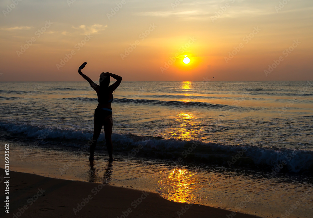 Woman body big with bikini and sunrise on beach Woman body big with bikini and sunrise on beach