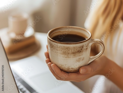 Cozy Workspace with Coffee Mug and Laptop in Warm Lighting