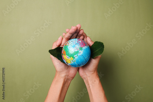 Palms Hands Holding Globe And Leaf Over Green Background. Save The Planet. Earth Day