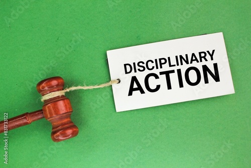 paper tag and judge's gavel with the word disciplinary action. the concept of disciplinary action. disciplined concept. attitude concept photo