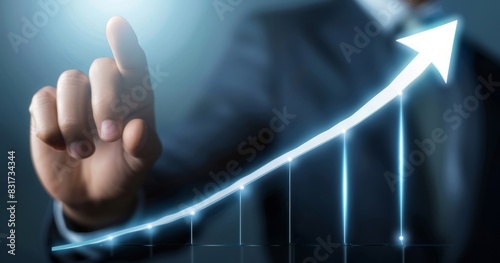 Businessman points to upwardly sloping line on bar graph. photo