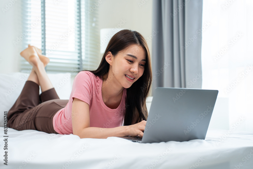 Asian attractive woman using laptop chat on bed at home in the morning. Asian attractive woman using laptop chat on bed at home in the morning.