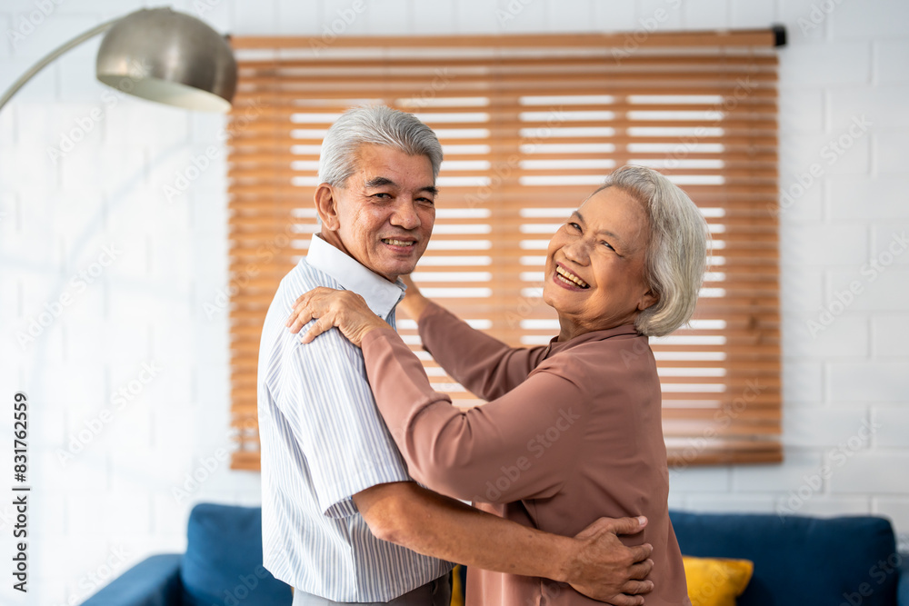 Portrait of Asian senior couple dance together in living room at home. Portrait of Asian senior couple dance together in living room at home.
