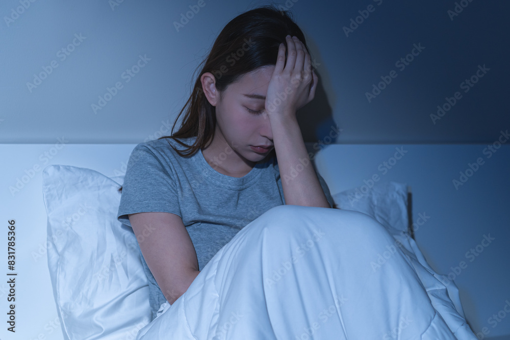 Sad worried and stressed, depressed asian young woman, girl suffering in bed from insomnia problem, awake at night, hand covering face from trouble disturbed loud noise, unable sleep. Restless people. Sad worried and stressed, depressed asian young woman, girl suffering in bed from insomnia problem, awake at night, hand covering face from trouble disturbed loud noise, unable sleep. Restless people.