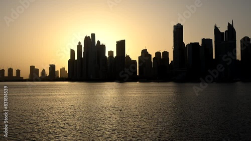 Wallpaper Mural The sun sets over a bustling city, casting a warm glow over the urban landscape of Dubai Torontodigital.ca